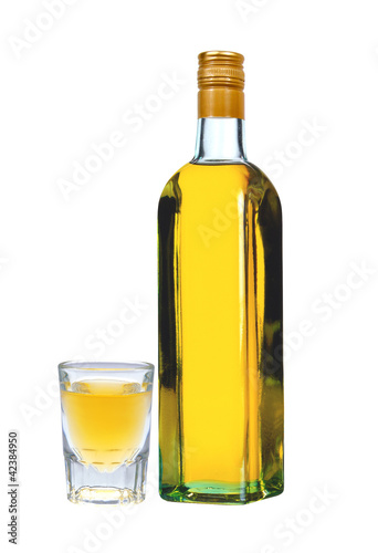 bottle of vodka with pepper and glass isolated on white