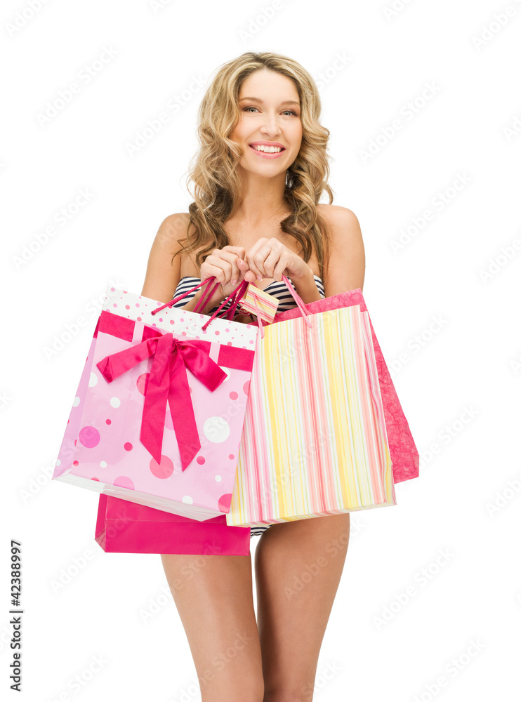 seductive woman in bikini with shopping bags