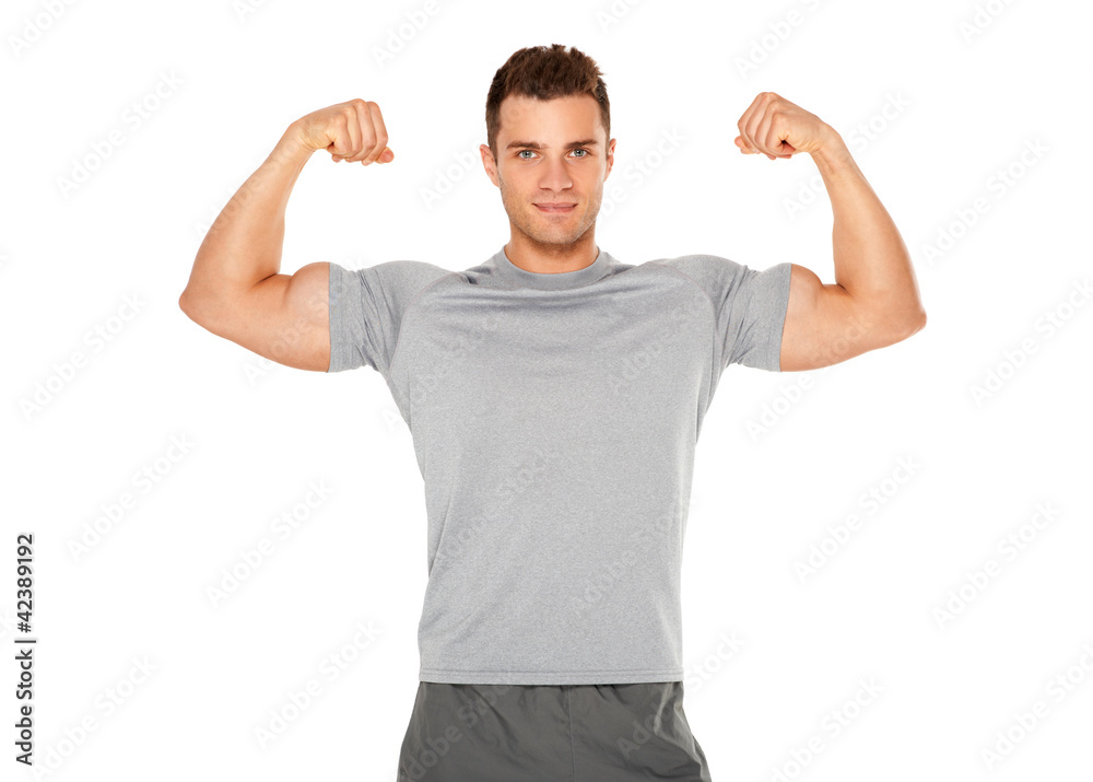 Fit and muscular man flexing his biceps on white