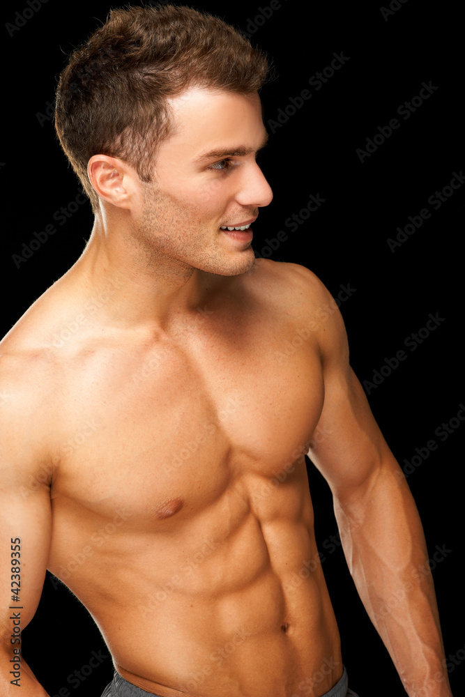 Portrait of a male athlete muscular on black