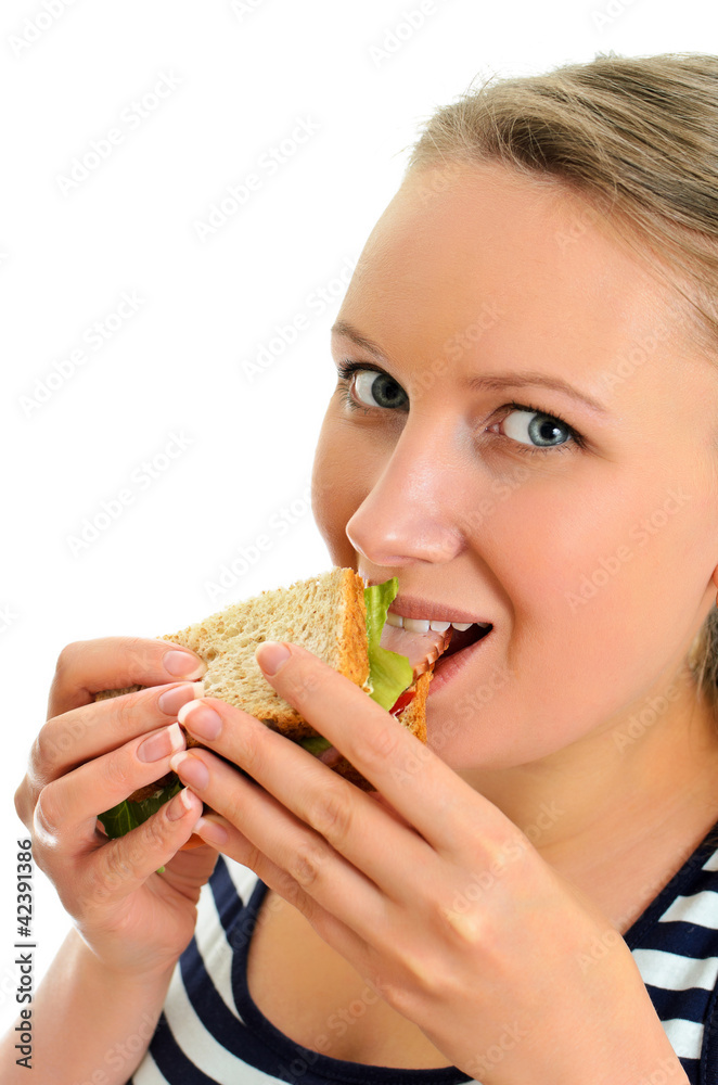 Attractive female eating sandwich, isolated on white Attractive female eating sandwich, isolated on white