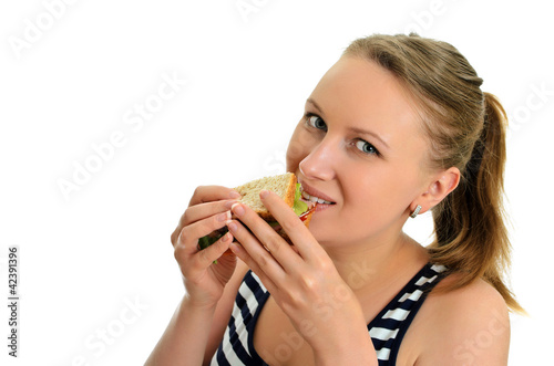 Attractive female eating sandwich  isolated on white