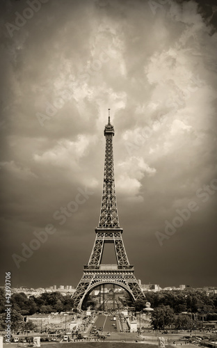 Fototapeta Naklejka Na Ścianę i Meble -  Vintage styled image of Eiffel tower during daytime, sepia toned against the dramatic sky. Paris, France