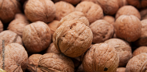 Brown raw walnuts textured background
