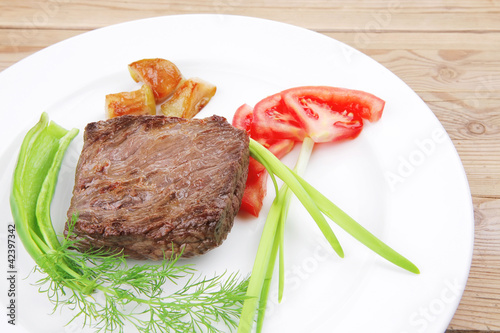 meat food : roasted fillet mignon on white plate with tomatoesan