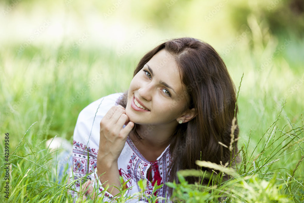 Slav teen girl at green meadow in national ukrainian clothing. Slav teen girl at green meadow in national ukrainian clothing.