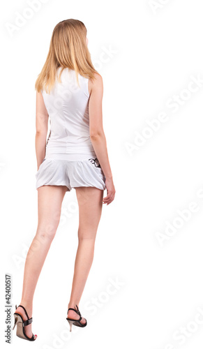 back view of going woman in shorts