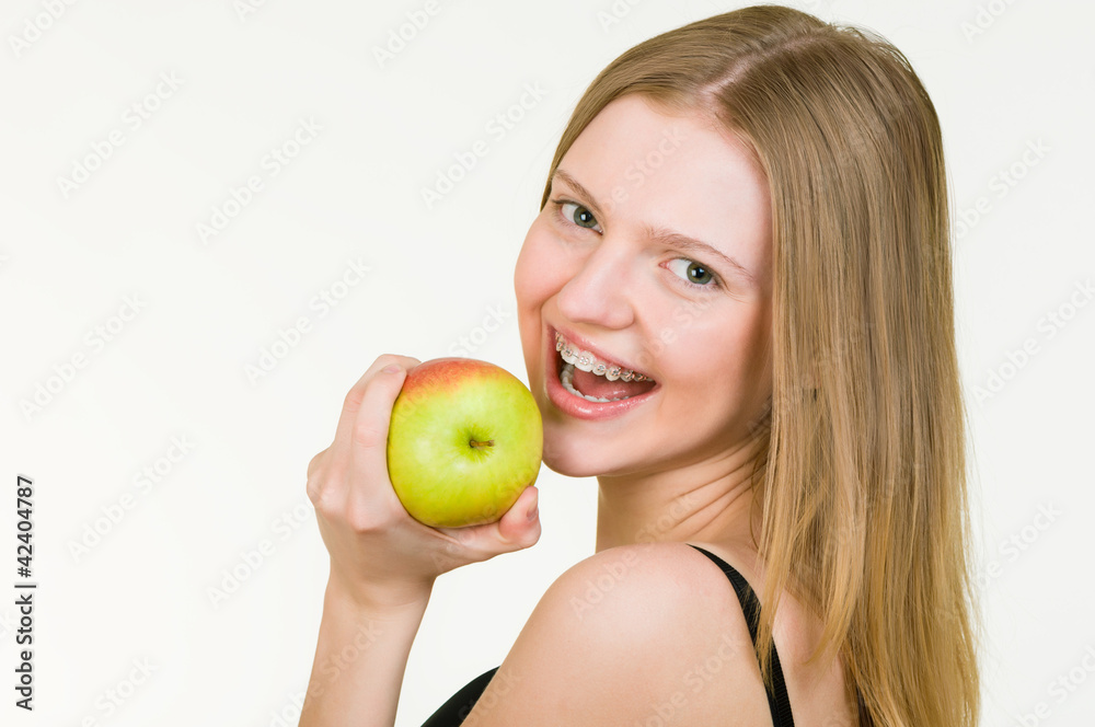 Beautiful Young woman with brackets eating apple Beautiful Young woman with brackets eating apple