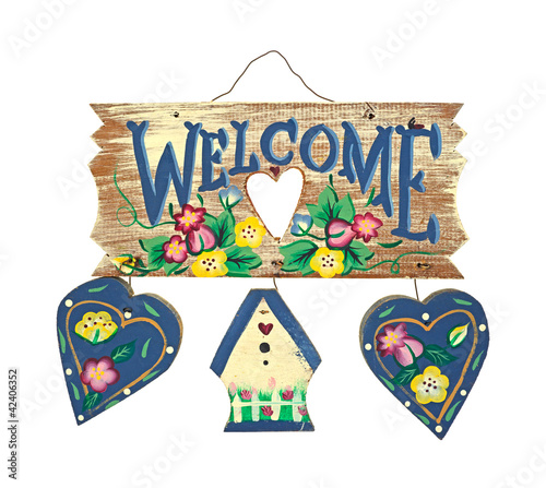 Welcome sign with two wood hearts and a small cottage