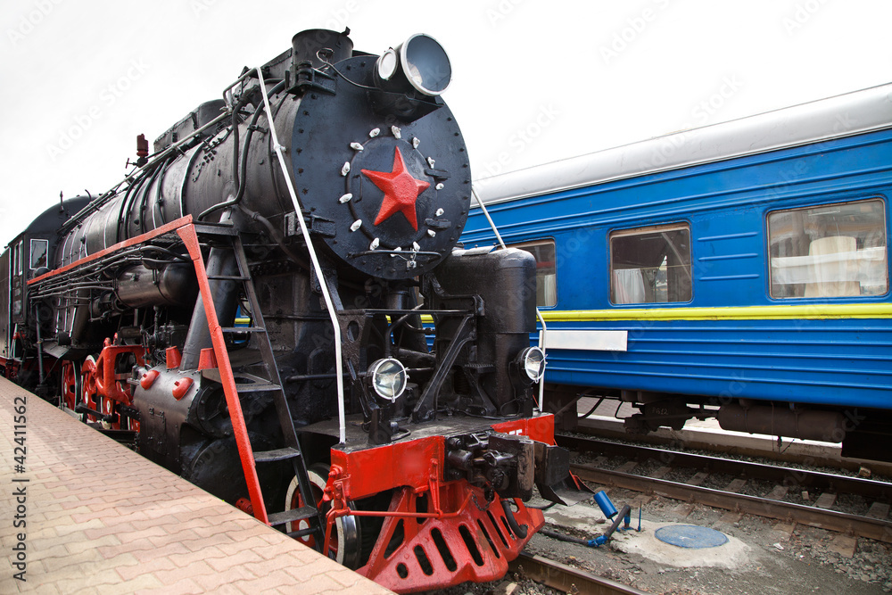 Obraz premium Old steam train is leaving a station