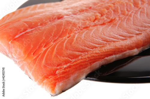 fresh uncooked red fish fillet on black