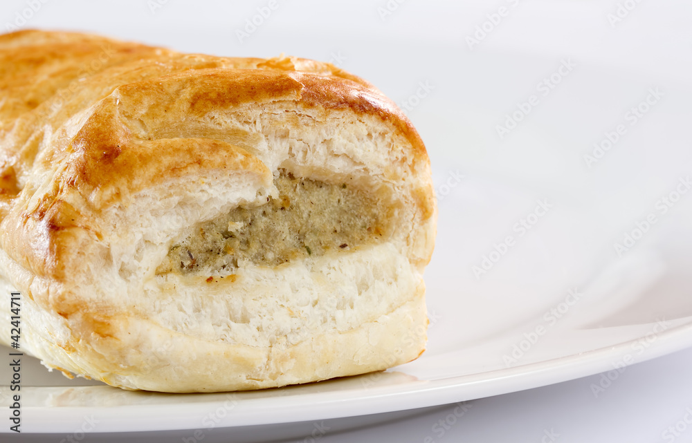 Sausage roll on a white plate