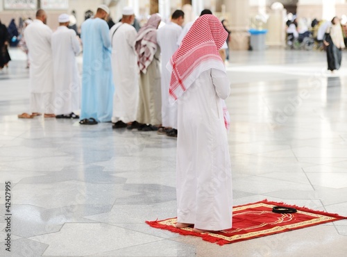 Muslims praying together at Holy mosque photo