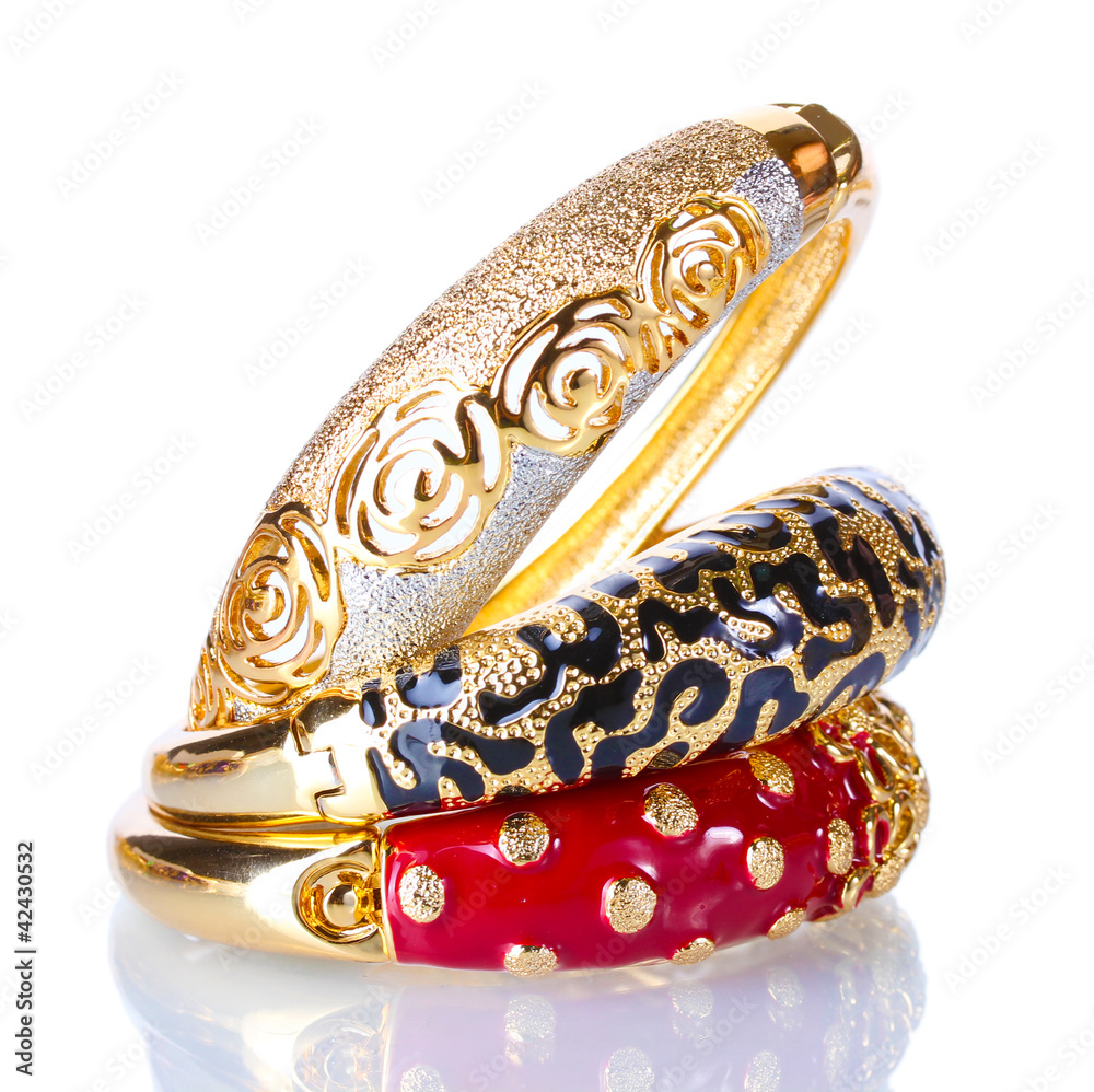 Beautiful golden bracelets isolated on white Beautiful golden bracelets isolated on white