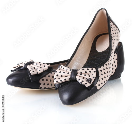 Female flat ballet shoes patterned with black polka