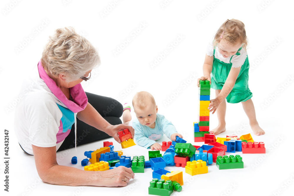 grandmother with grandchildren playing with blocks grandmother with grandchildren playing with blocks