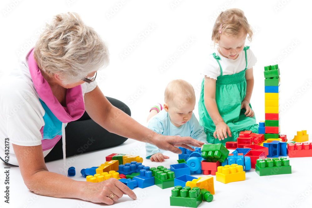 grandmother with grandchildren playing with blocks grandmother with grandchildren playing with blocks