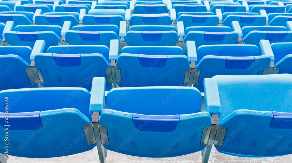 Naklejka premium Blue empty plastic seats at stadium