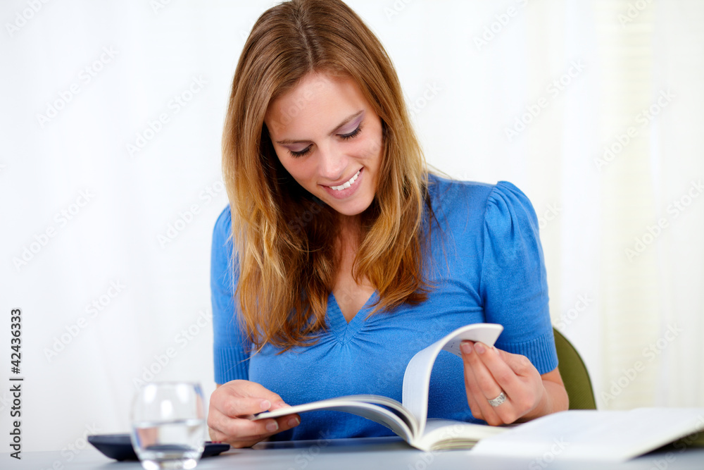 Caucasian blonde woman smiling and reading Caucasian blonde woman smiling and reading