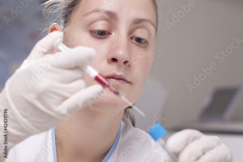 Injecting blood in test tube