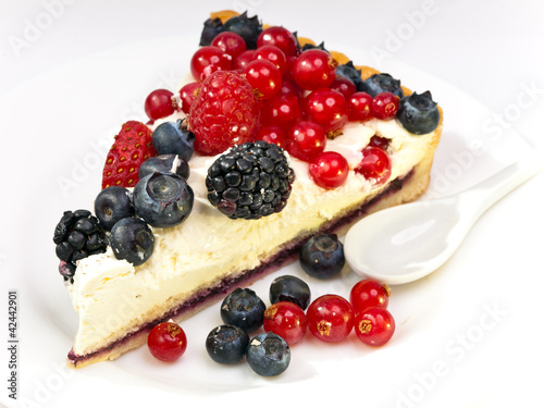 Piece of a pie with fresh berries on a plate