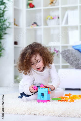 Little girl playing on floor