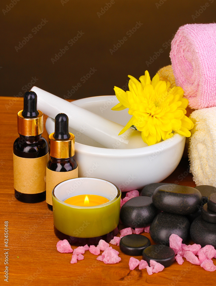 Spa setting on wooden table on brown background Spa setting on wooden table on brown background
