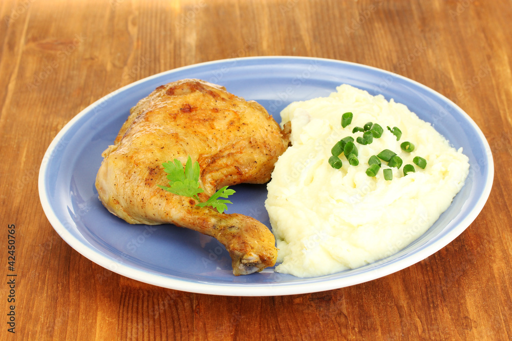 roasted chicken leg with mashed potato in the plate