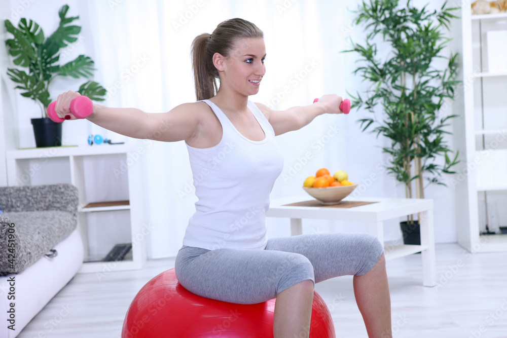 Young woman doing fitness exercise with dumbbell Young woman doing fitness exercise with dumbbell