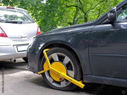 Obraz na plátně Wheel clamp mounted on wrong parking car