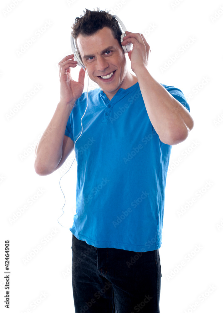 Attractive guy holding headphones Attractive guy holding headphones