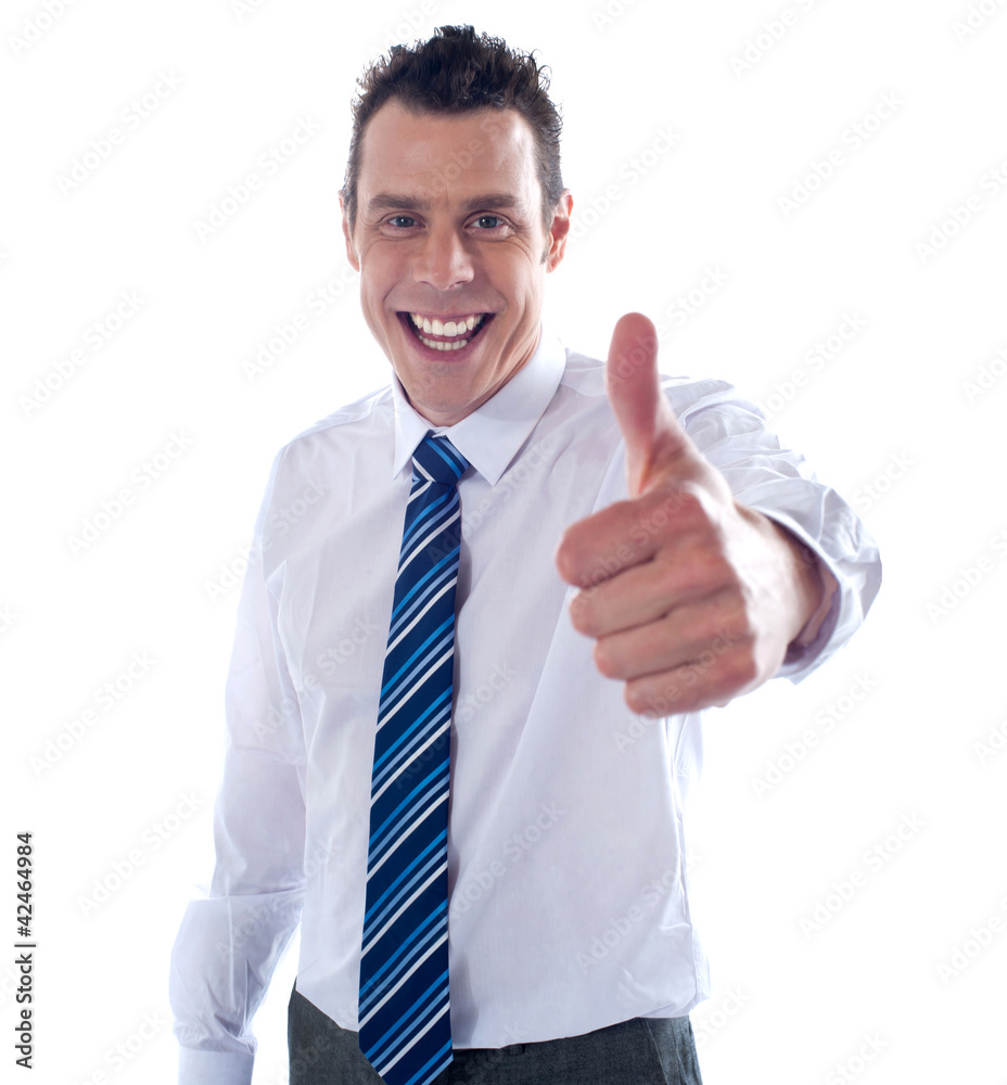 Young executive showing thumbs up