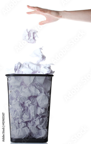 hand going garbage in metal trash bin from paper isolated