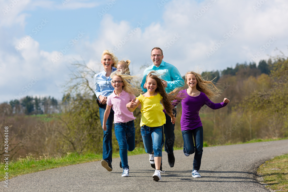 Familie - Mutter, Vater, Kinder - joggt im Freien