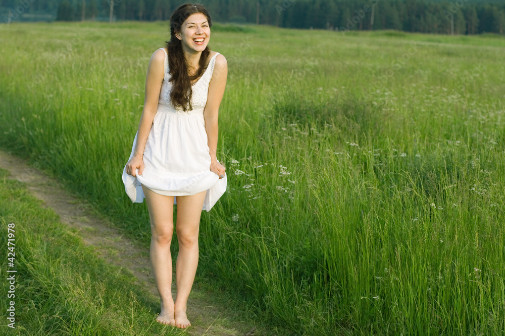 Lucky girl standing barefoot in a field. Lucky girl standing barefoot in a field.