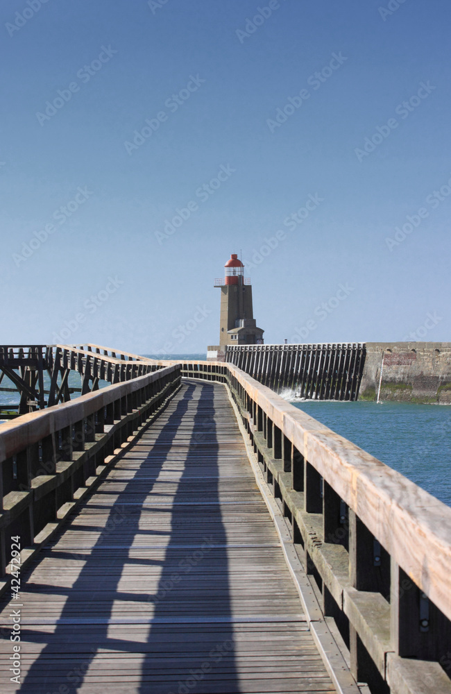 wooden pier and  lighthouse of the port of fécamps in france