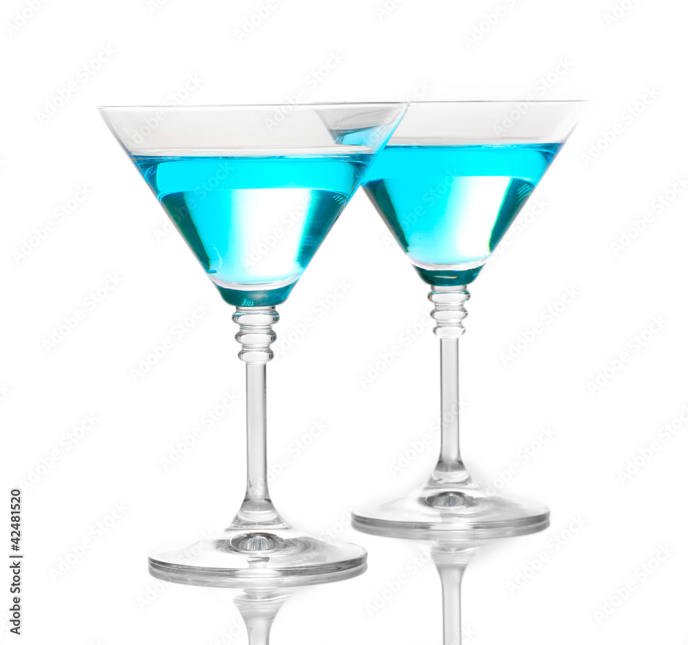 Blue cocktail in martini glasses isolated on white
