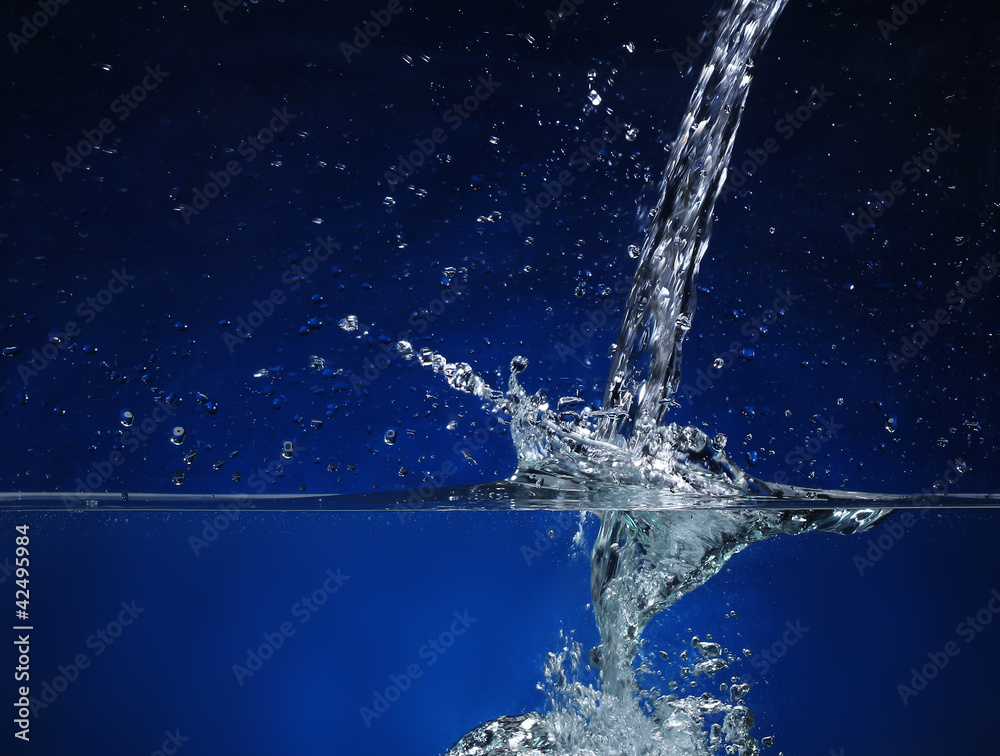 Pouring water. Splash image on a blue background Pouring water. Splash image on a blue background