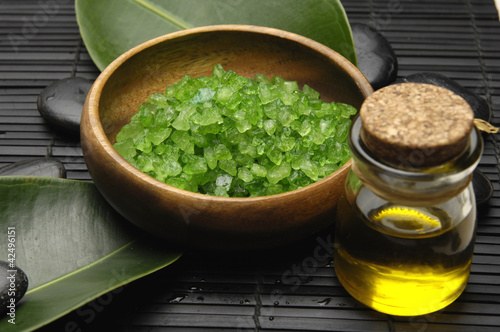 bath salt and green leaf with essential oil on mat