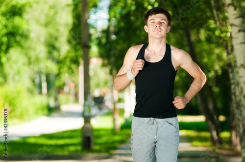 Young man jogging in park © mr.markin