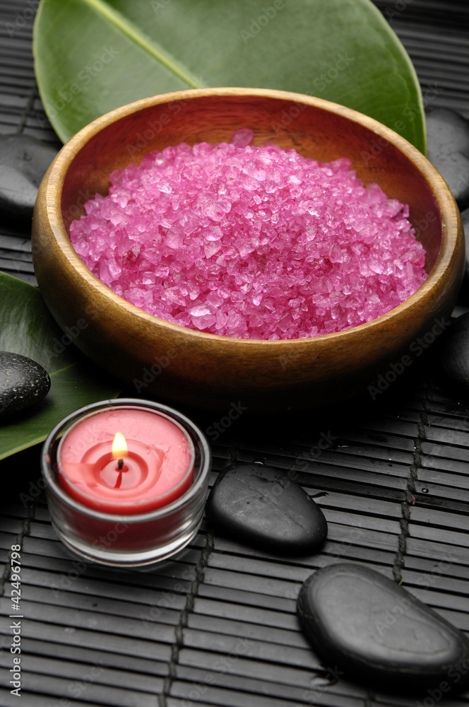 herbal salt in bowl and green leaf and stones on bamboo on mat herbal salt in bowl and green leaf and stones on bamboo on mat