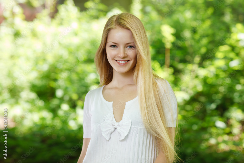 Closeup of young smiling woman on background of summer nature Closeup of young smiling woman on background of summer nature