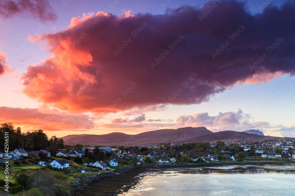 Colorful clouds at sunset  over a village
