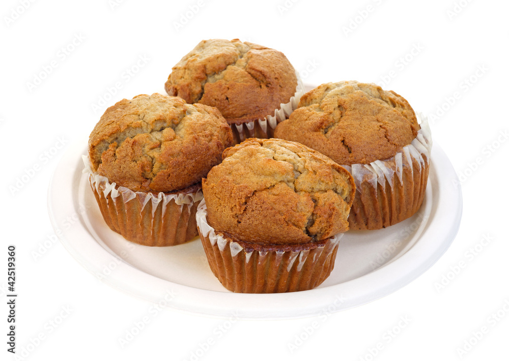 Four apple spice muffins on paper plate