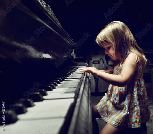 girl playing on an  piano.