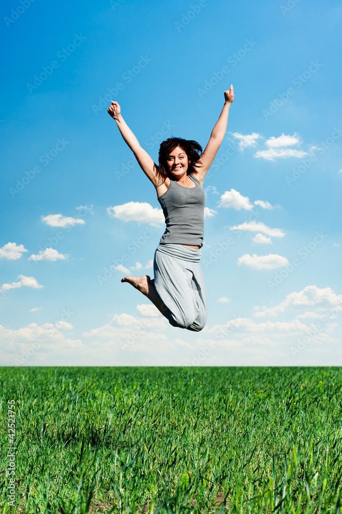 woman jumping at the field at sunny day woman jumping at the field at sunny day
