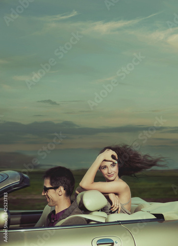 Young couple in cabriolet © konradbak