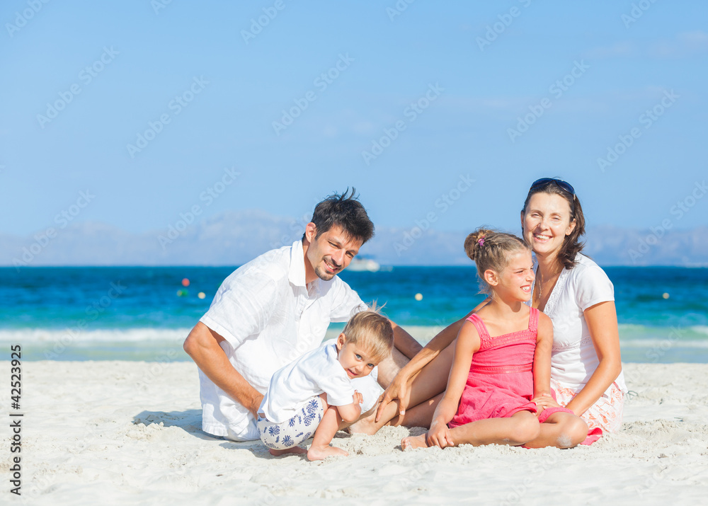 Family of four on tropical beach Family of four on tropical beach