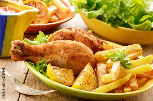 Fried drumsticks with french fries