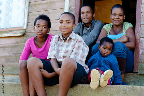 Obraz na płótnie Family on the porch in front of their home.